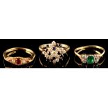 An emerald & diamond ring, the rounded rectangular emerald flanked by two pairs of small diamonds,