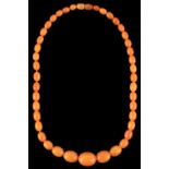 A butterscotch amber oval bead necklace, the largest bead approximately 21mm long, approximately