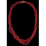 A cut ruby bead four row necklace, the yellow metal clasp marked 585, approximately 22ins. (