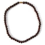 A garnet bead necklace, the uniform beads approximately 8mm diameter, approximately 16.25ins. (