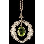 An 18ct white gold peridot & diamond laurel wreath pendant, with suspended oval cut peridot