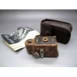Toys - A Coronet Midget Bakelite Camera, finished in brown. Some discolouration to front metal