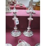 A Pair of XIX Century Plated Candlesticks, each tapering stem on spreading shaped circular base, the