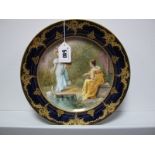 A Late XIX Century Vienna Porcelain Cabinet Plate, painted and gilt, centrally with a scene of two