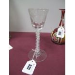 An XVIII Century Wine Glass, the ribbed and engraved bucket shaped bowl above a double opaque