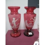 A Pair of Late XX Century Cranberry Glass Vases, white enamelled with scenes of children in the