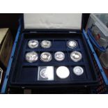 Ten Coins, regularly crown sized. Usually proof issues and sometimes silver. In a coin case. A