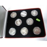 Man In Flight; a collection of eight crown sized coins by the Pobjoy Mint. In the fitted case of