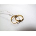 A 22ct Gold Plain Wedding Band, together with another (worn). (2)