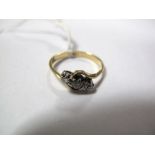 A Three Stone Ring, crossover set, stamped "18ct".