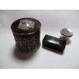 An Imitation Tortoiseshell Cylindrical Box and Cover, (damaged), with silver mounts and filigree