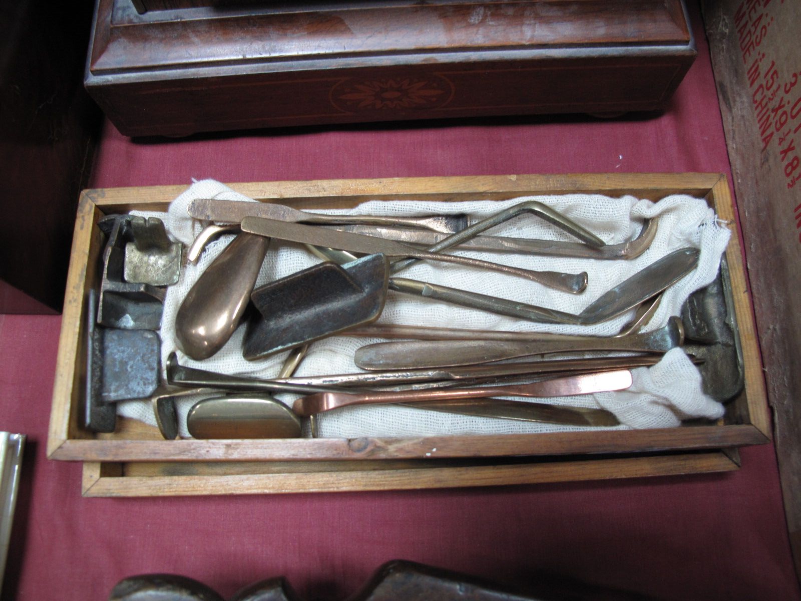 A Wooden Box, containing nineteen cast bronze, brass and copper plasterer's fine moulding tools.