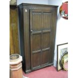 A XX Century Oak Wardrobe, frieze cut knulled decoration, panelled door with linen fold