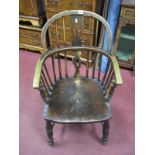 A XIX Century Ash Windsor Chair with low back, pierced central stretcher, and turned supports united