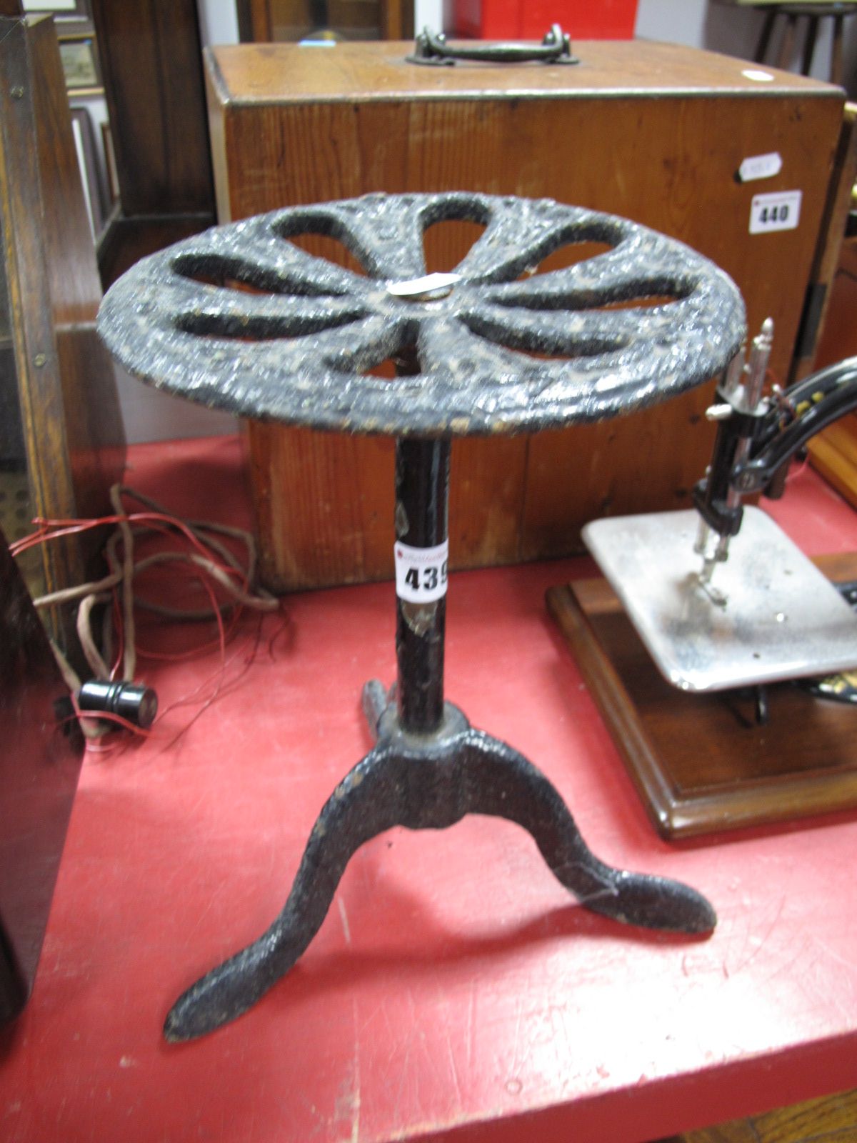 A Painted Cast Iron Stand, pierced circular top, plain column on tripod legs, height 29cms.