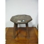 A Late XIX Century Oak Stool, with carved symmetrical motif and adzed work octagonal top, on splayed