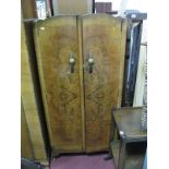 A Circa 1930's Burr Walnut Three Piece Bedroom Suite, comprising wardrobe, compactum, and dressing