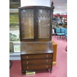 An Early XX Century Oak Bureau Bookcase, leaded glazed doors over fall front and drawers, raised