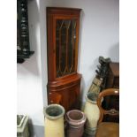 A Yew Wood Corner Cupboard, with a dentil cornice, glazed door, base, with a cupboard door, on