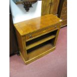 A Yew Wood Bookcase, with a crossbanded top, reeded legs, single drawer, single shelf, on a plinth