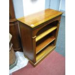 A Yew Wood Bookcase, with a dentil cornice, reeded sides, adjustable shelves, on a plinth base.