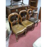 Three Mid XIX Century Mahogany Balloon Back Dining Chairs, carved central rail, studded leather seat