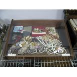 Brooches, bangles, necklaces, pendants, rings, earrings and other costume jewellery in perspex slope