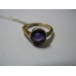 An Amethyst Single Stone Dress Ring, collet set, indistinctly stamped "18ct".