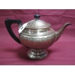 A Hallmarked Silver Teapot, makers mark rubbed, Birmingham 1939, of circular paneled form, raised on