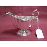 A Hallmarked Silver Sauce Boat, makers mark rubbed, Birmingham 1824, with reeded border and leaf