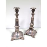 A Pair of Continental Candlesticks, each shaped base on paw feet supporting tapering knopped
