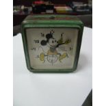 A 1930's Mickey Mouse Ingersoll Clock. Face finished in black and yellow with green case. Mickey has