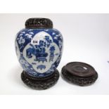 A Chinese Porcelain Ginger Jar and Cover, of ovoid form, blue and white painted with reserved panels