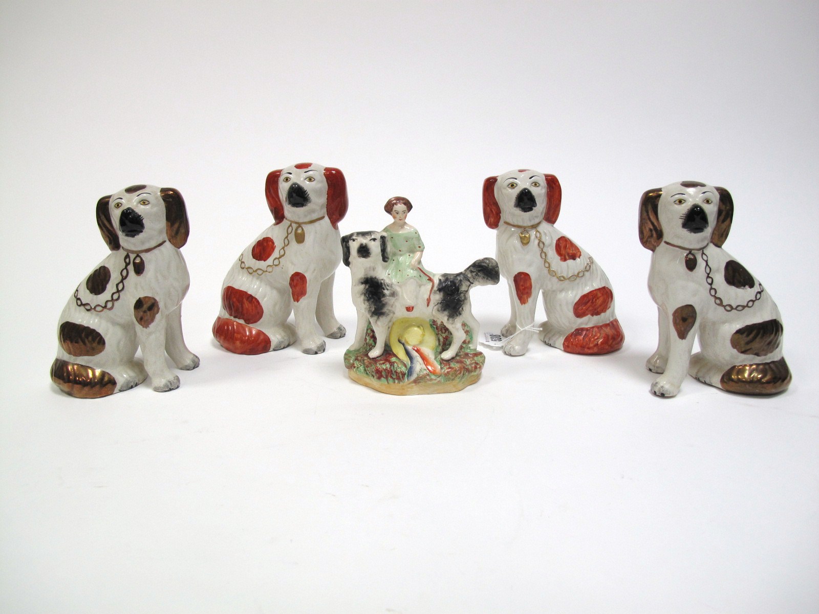 A XIX Century Staffordshire Pottery Figure Group, of maiden upon large dog with yellow hat to