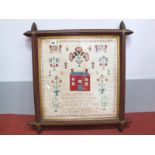 A Late Victorian Cross Stitch Sampler, centrally with a cottage and other pictorial devices above
