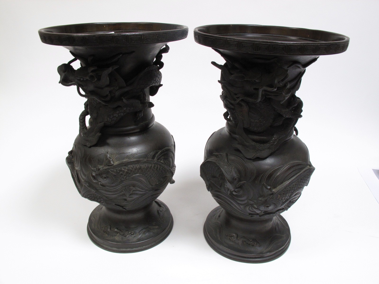 A Pair of Late XIX Century Japanese Cast Bronze Vases, of baluster pedestal form, relief decorated
