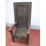 A XIX Century Carved Oak Chair / Table, the fold over top with carved patera and border and