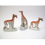 A XIX Century Staffordshire Pottery Greyhound Dog, hind legs squatting, with game by its side, on