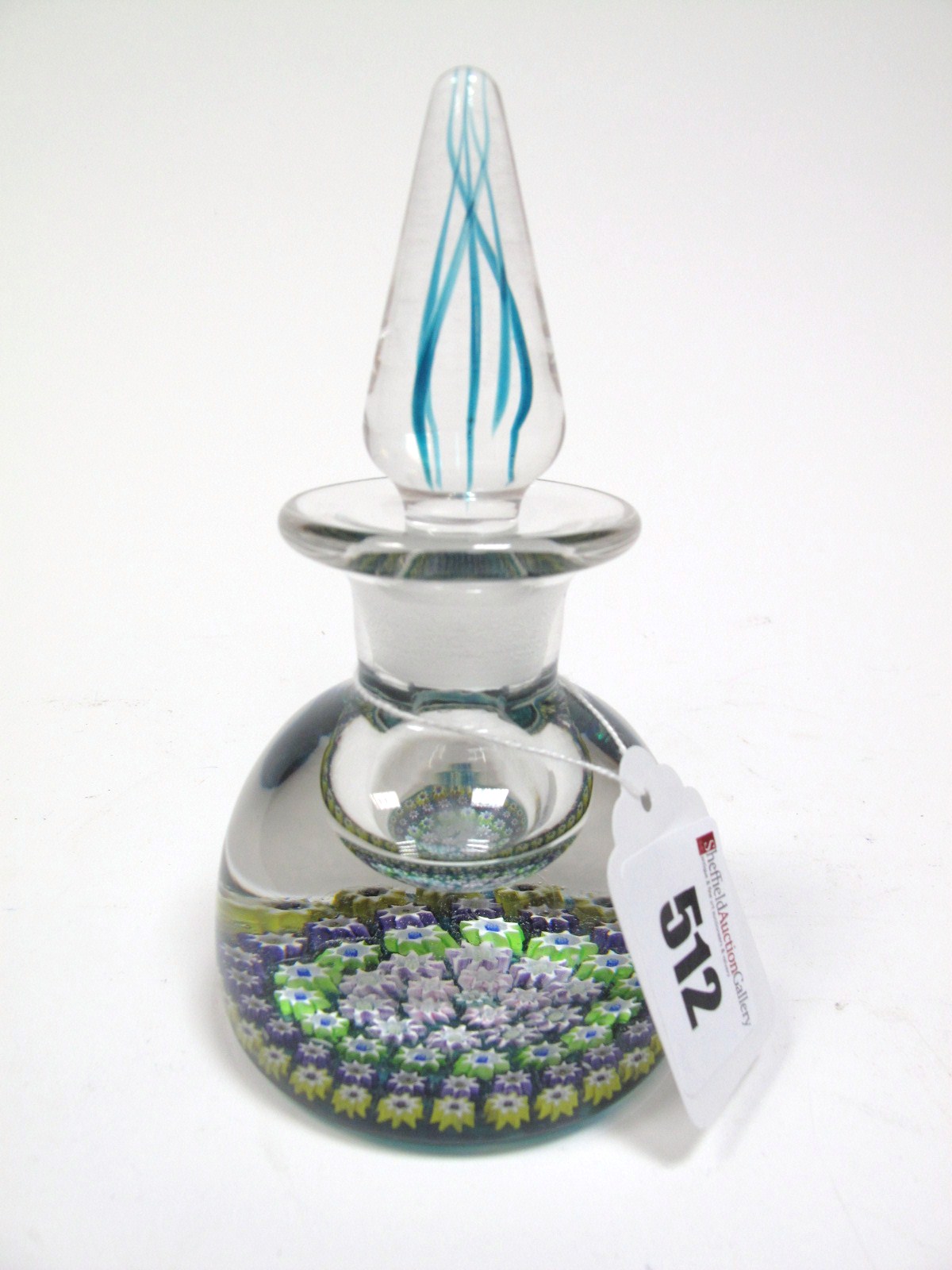 A Perthshire Inkwell Paperweight, the compressed blue tinted base set with concentric millfiore