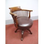 An Early XX Century Mahogany Office Swivel Chair, with shaped top rail and arms, rail supports and