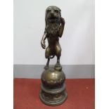 A Large Bronzed Figure of a Lion Rampant, standing on a ball, on circular base with 'C' scroll