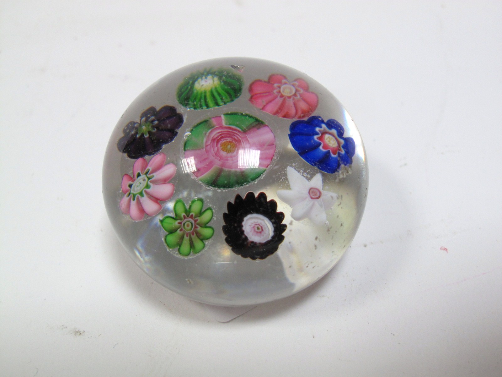 A Clichy Spaced Millefiore Paperweight, circa 1850, with central pink and green rose cane to eight