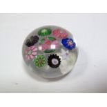 A Clichy Spaced Millefiore Paperweight, circa 1850, with central pink and green rose cane to eight