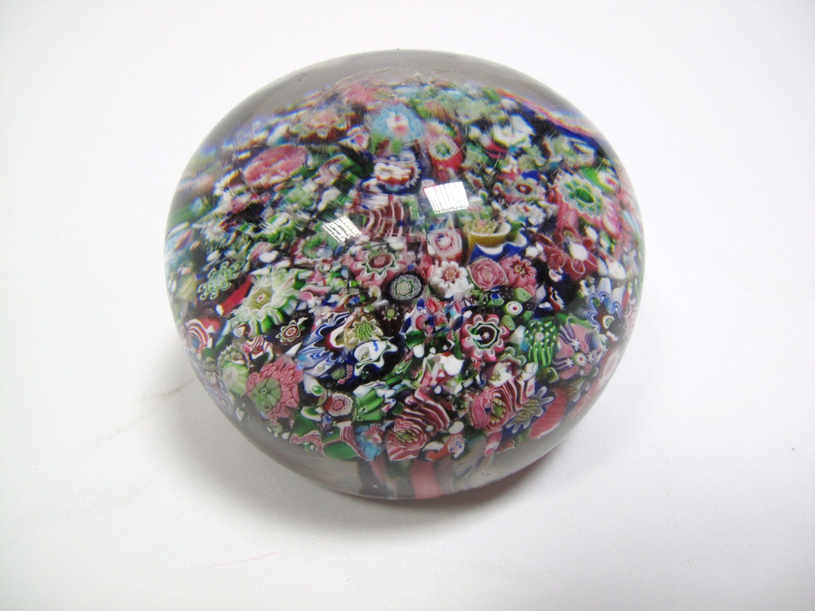 A XIX Century Clichy Style Millefiore Paperweight, with close packed rose and other floral canes