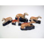 A Pair of XIX Century Staffordshire Pottery Inkwells, in the form of recumbent greyhound, upon