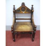 A XIX Century Gothic Style Armchair, with arched and carved top rail, central panel bearing
