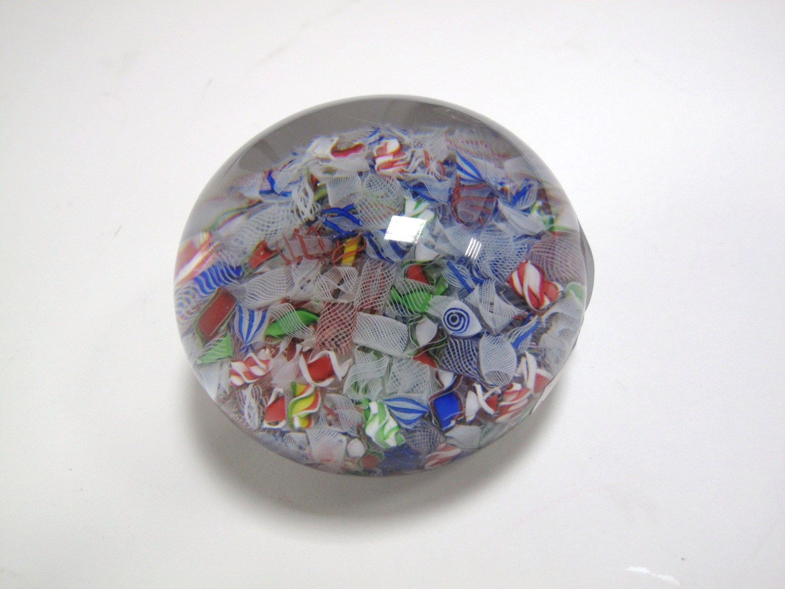 A c.1850 Baccarat Macedoine Millefiore Paperweight, with multi-coloured  and latticino canes,
