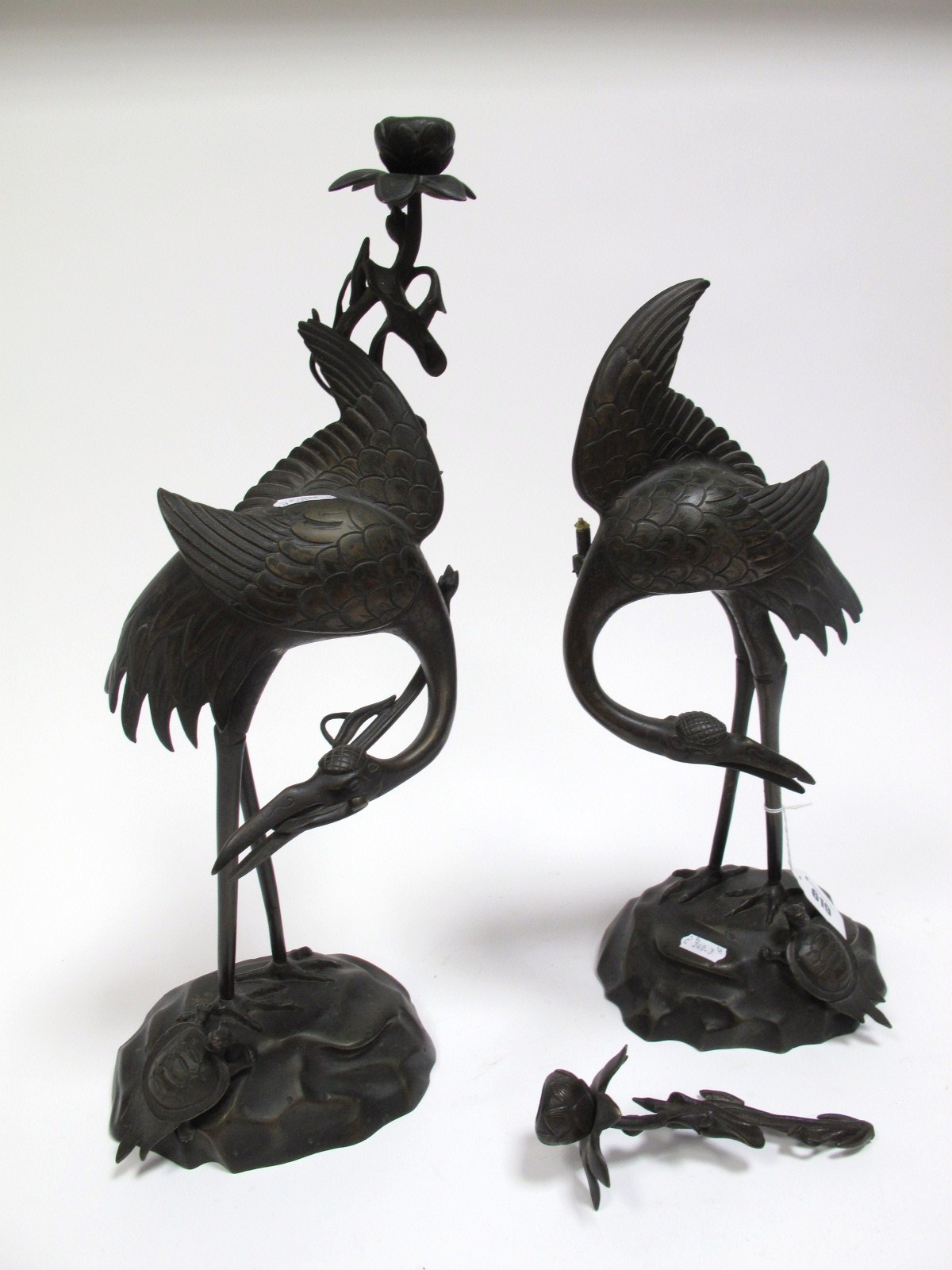 A Pair of Late XIX Century Japanese Cast Bronze Candlesticks, each as a crane holding a lotus branch