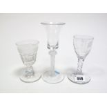 An XVIII Century Wine Glass, the trumpet shaped bowl on a knopped clear twist stem and circular