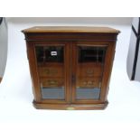 An Edwardian Oak Presentation Smokers Cabinet, of rectangular form with canted front angles, two